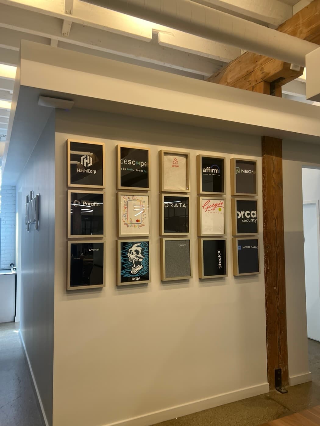 Wall of framed portfolio company logos at Notable Capital